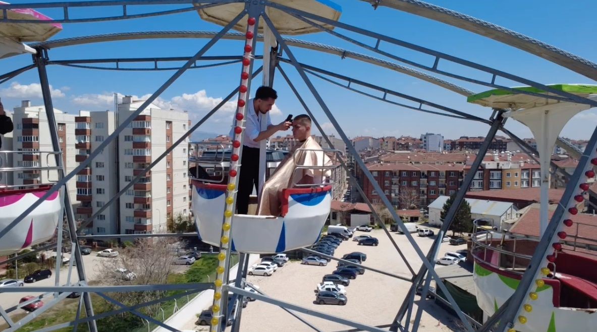 Dönme dolabın zirvesinde macera dolu saç kesimi